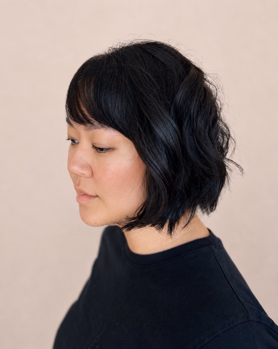 Blue-black textured bob cut to fall just below the jaw.