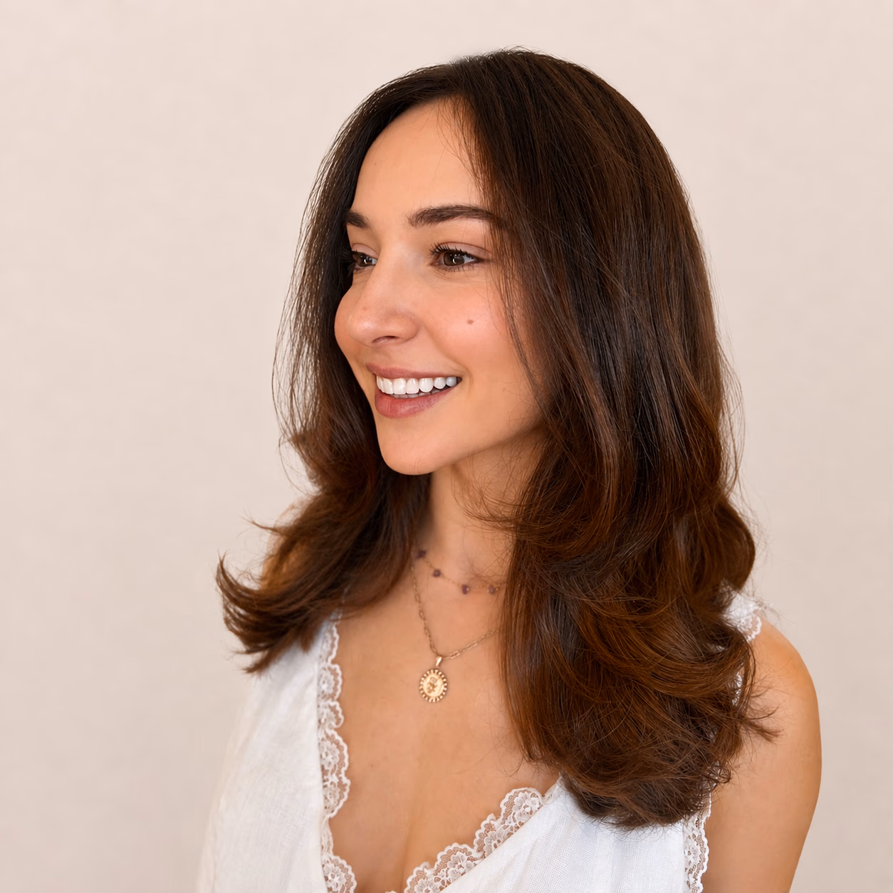 Polished blowout on mid-length brunette hair.